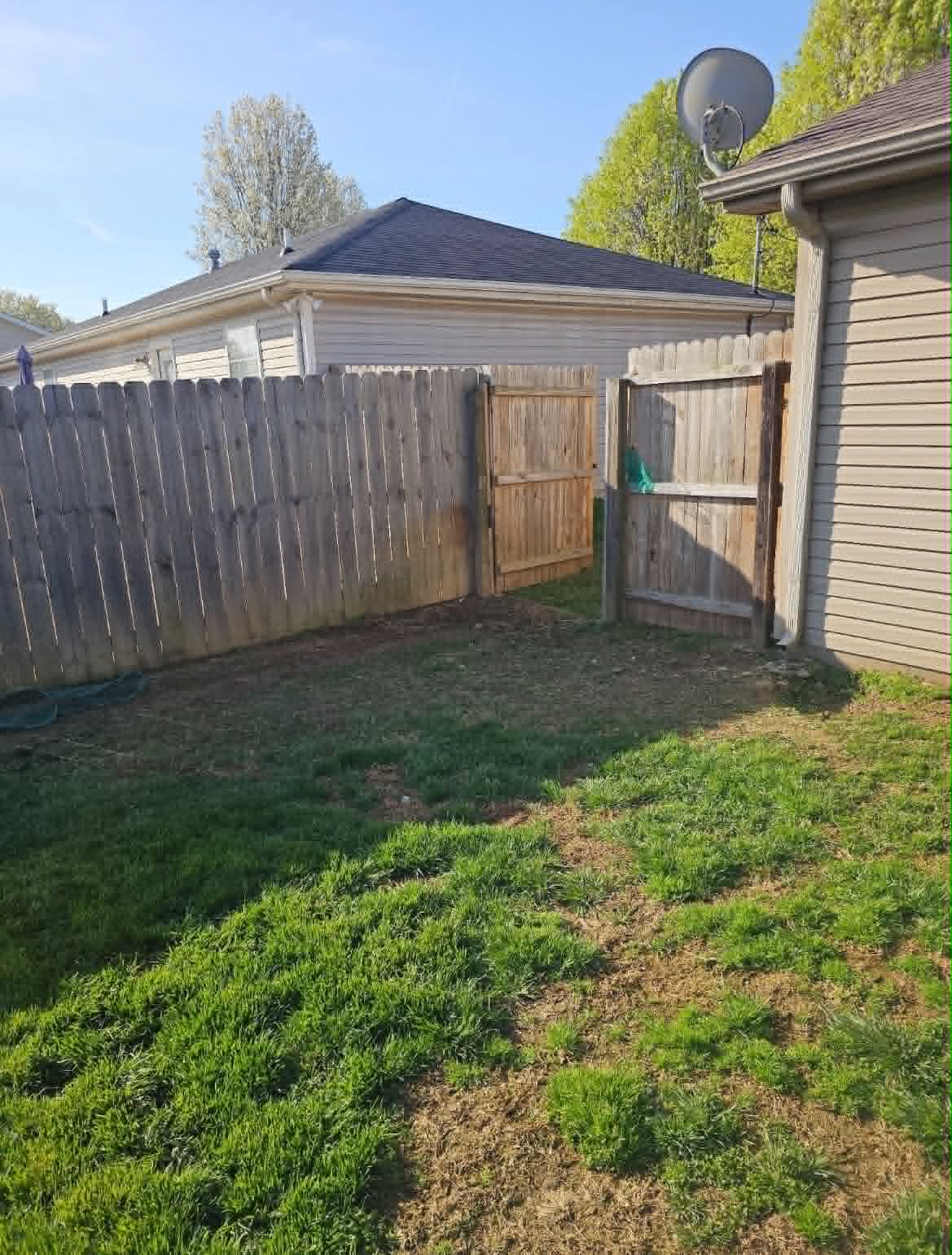 Fence gate area with lawn cleanup and trimming work
