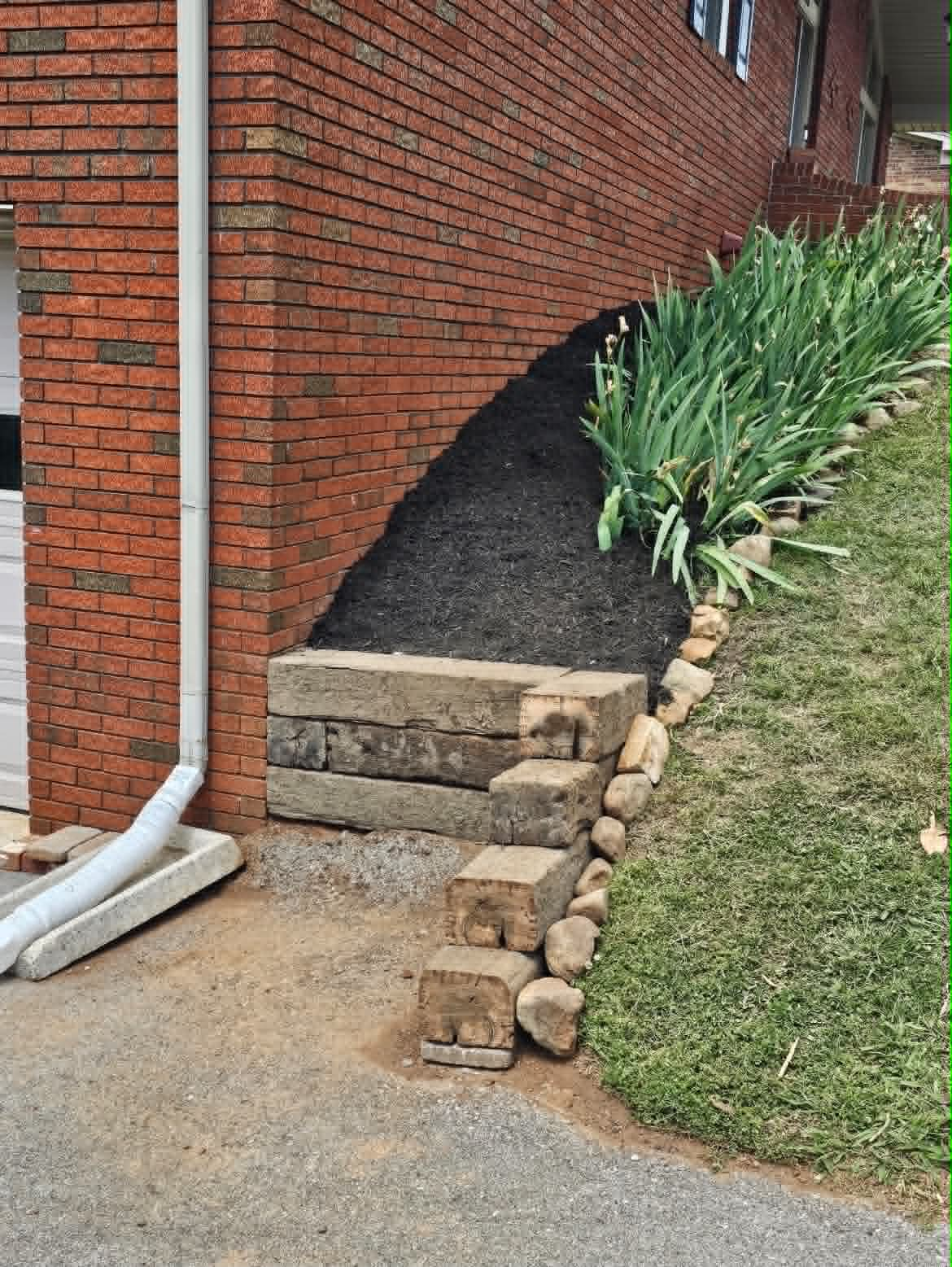 Wide view of the completed retaining bed and refreshed planting area