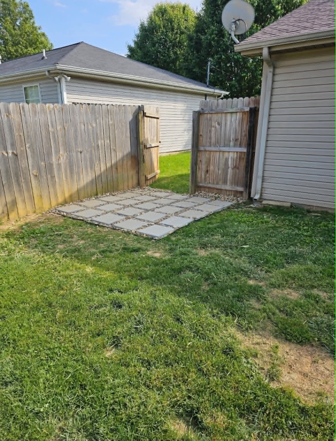 Before view of a backyard gate area before paver installation