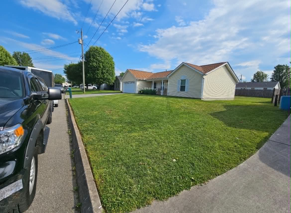 Wide angle view of a freshly cut front lawn and home exterior